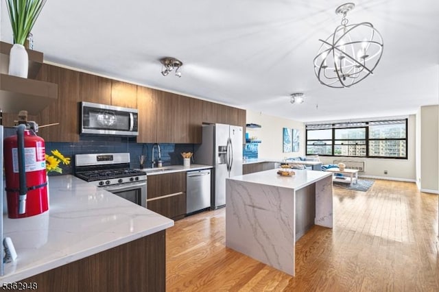 7002 Kennedy Blvd Unit 36G, Guttenberg Town, NJ 07093 - kitchen featuring stainless steel appliances, a sink, a chandelier, modern cabinets, and decorative backsplash