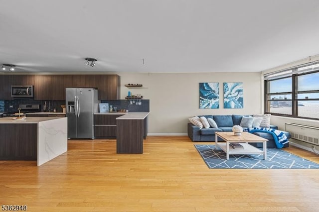 7002 Kennedy Blvd Unit 36G, Guttenberg Town, NJ 07093 - kitchen with appliances with stainless steel finishes, light countertops, dark brown cabinetry, modern cabinets, and backsplash