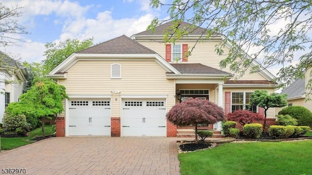 9 Independence Ct, Franklin Twp, NJ 08873 - view of front of property with decorative driveway, a garage, brick siding, a front yard, and a shingled roof