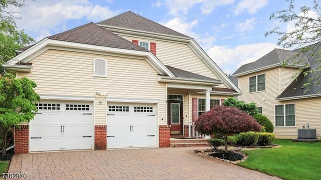 9 Independence Ct, Franklin Twp, NJ 08873 - view of front of home with decorative driveway, brick siding, and a front yard
