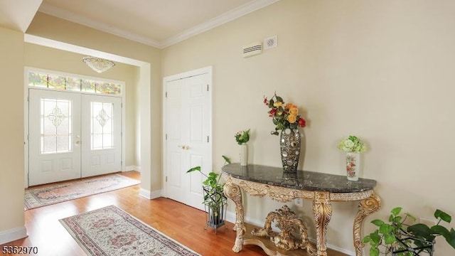 9 Independence Ct, Franklin Twp, NJ 08873 - foyer featuring wood finished floors, crown molding, and french doors