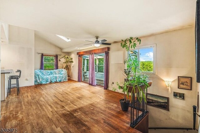 16 Sunset Trl, Rockaway Twp, NJ 07866 - living area featuring ceiling fan, wood finished floors, vaulted ceiling, plenty of natural light, and a skylight