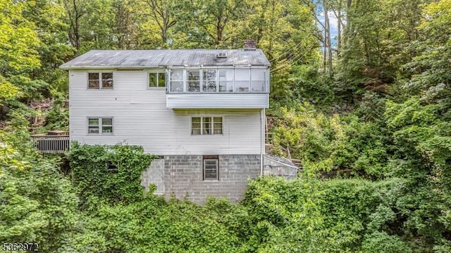 16 Sunset Trl, Rockaway Twp, NJ 07866 - rear view of property with a chimney and a wooded view