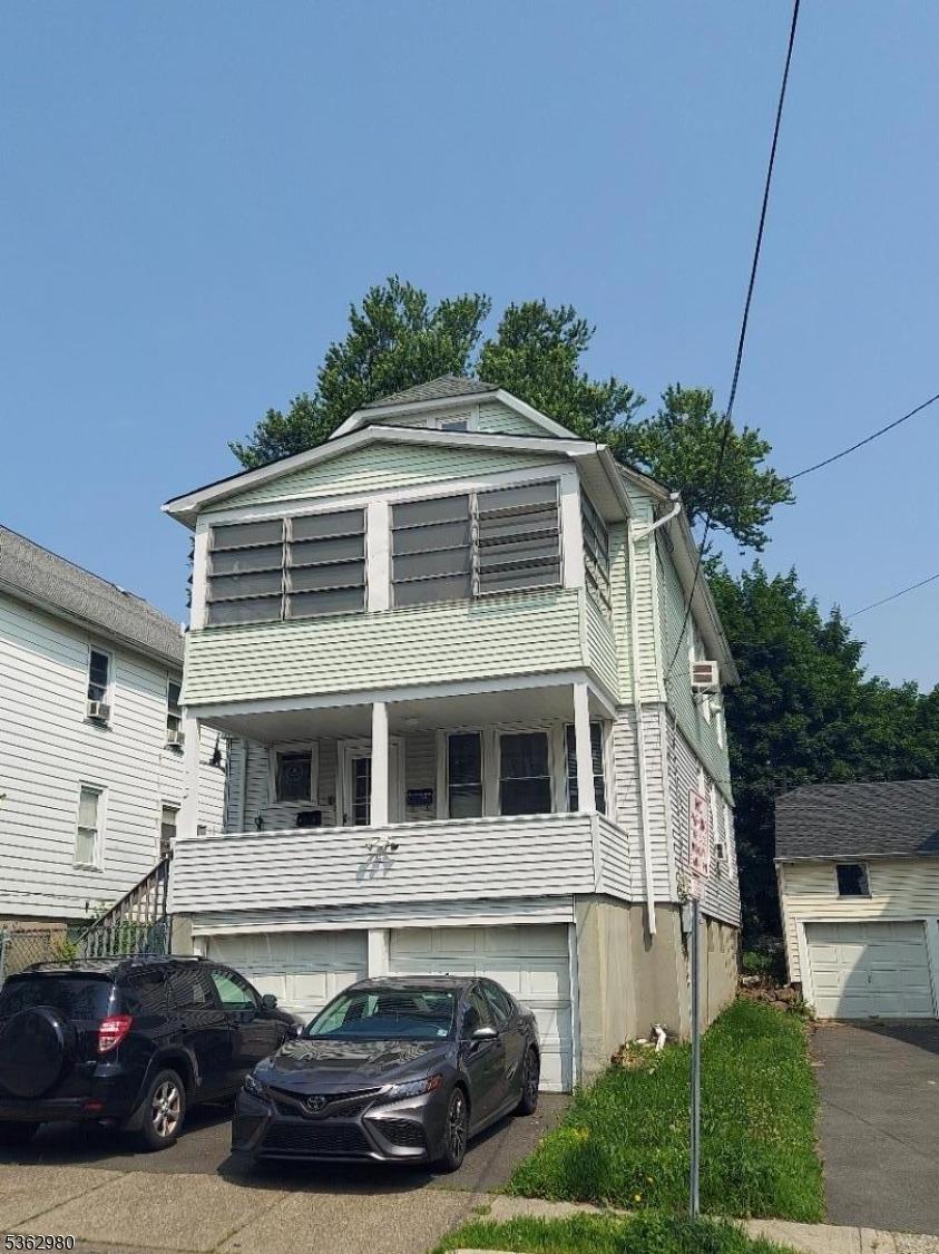8 N 12th St, Hawthorne Boro, NJ 07506 - view of front facade featuring a garage