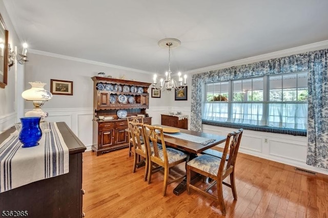 500 Charlestown Rd, Bethlehem Twp, NJ 08827 - dining room with a chandelier, crown molding, a decorative wall, a wainscoted wall, and light wood finished floors