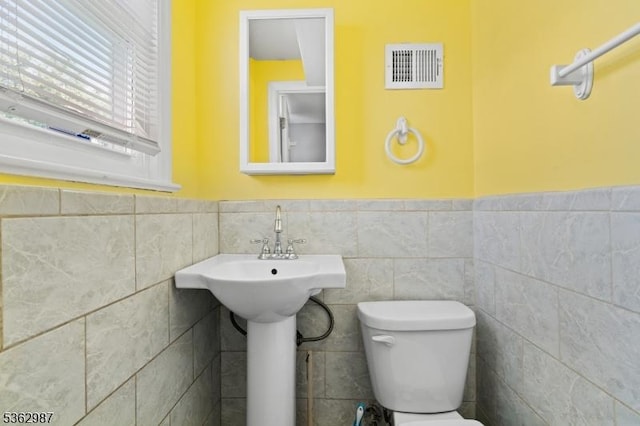 315 D St, Middlesex Boro, NJ 08846 - bathroom with toilet, a wainscoted wall, and tile walls