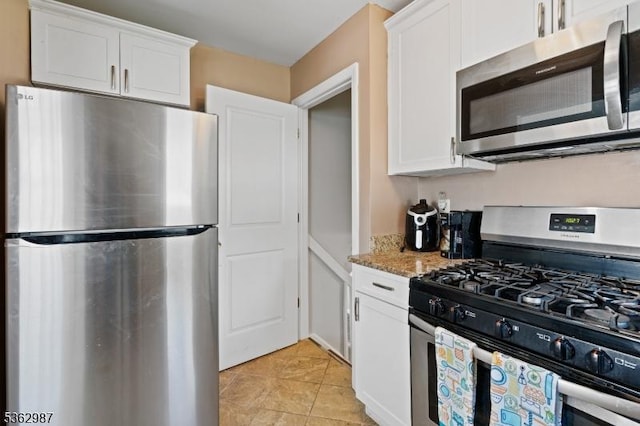 315 D St, Middlesex Boro, NJ 08846 - kitchen with stainless steel appliances, white cabinetry, light stone countertops, and light tile patterned floors