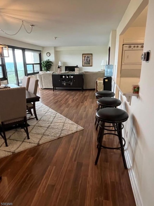 2 Claridge Dr Unit 7Ie, Verona Twp, NJ 07044 - living room featuring stacked washer and clothes dryer and dark wood-type flooring