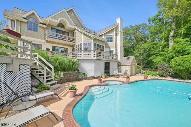 6 Summit Ter, Kinnelon Boro, NJ 07405 - back of house with a patio, a pool with connected hot tub, stairway, and a chimney