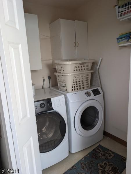 6 Summit Ter, Kinnelon Boro, NJ 07405 - laundry room featuring separate washer and dryer, cabinet space, and light tile patterned floors