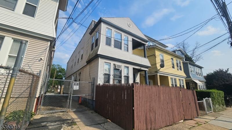 144 Alexander St, Newark City, NJ 07106 - view of side of home featuring a gate