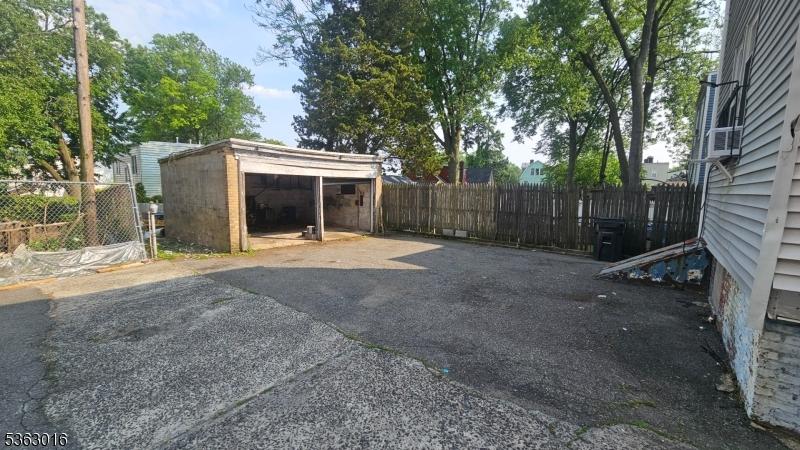 144 Alexander St, Newark City, NJ 07106 - view of car parking featuring a garage