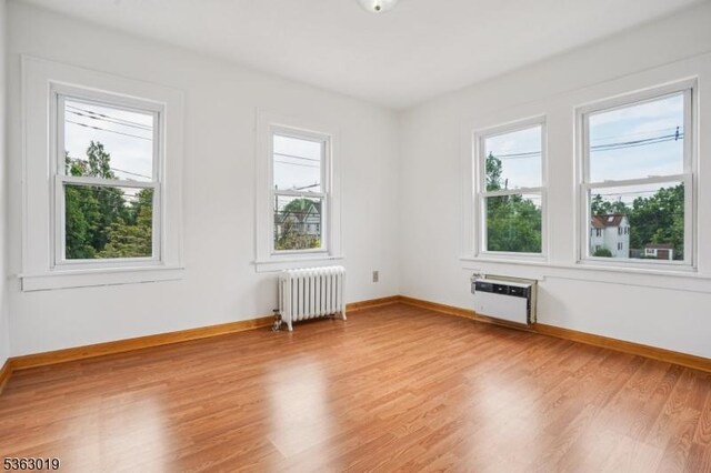 303 Tuttle Pkwy, Westfield Town, NJ 07090 - spare room with radiator, healthy amount of natural light, and light wood-type flooring