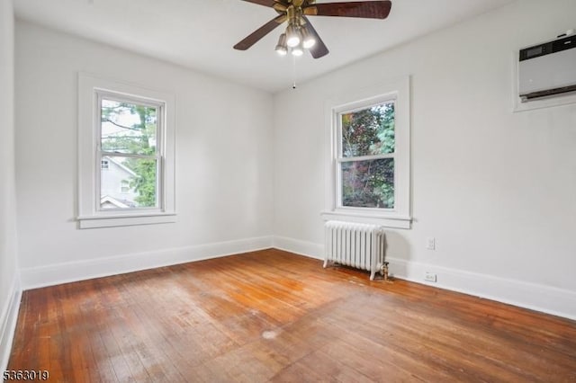 303 Tuttle Pkwy, Westfield Town, NJ 07090 - spare room featuring radiator heating unit, plenty of natural light, wood-type flooring, and ceiling fan