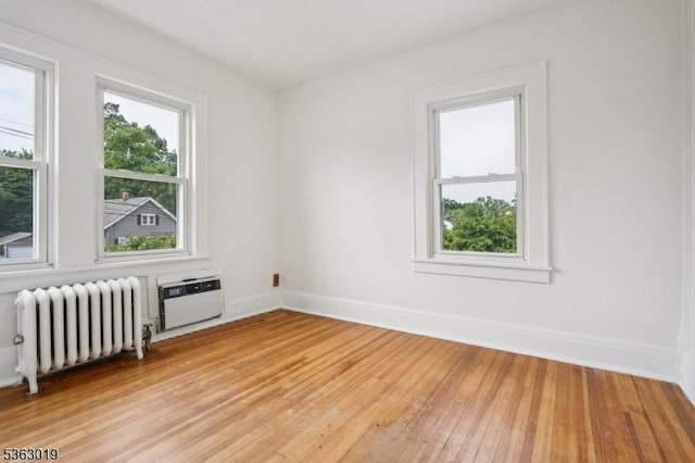 303 Tuttle Pkwy, Westfield Town, NJ 07090 - unfurnished room featuring radiator, light wood-style floors, and a wall mounted AC