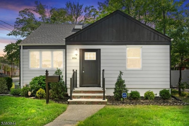 856 Maurice Ave, Rahway City, NJ 07065 - bungalow-style house featuring a front lawn, a shingled roof, and board and batten siding
