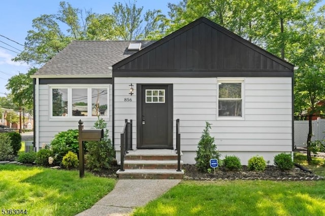 856 Maurice Ave, Rahway City, NJ 07065 - view of front of property featuring a front yard, board and batten siding, and a shingled roof