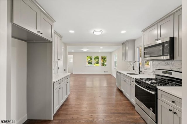 856 Maurice Ave, Rahway City, NJ 07065 - kitchen featuring stainless steel appliances, a sink, wood finished floors, backsplash, and recessed lighting