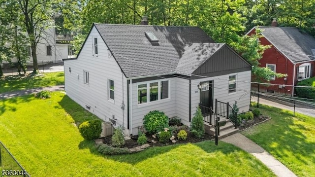 856 Maurice Ave, Rahway City, NJ 07065 - view of front of house featuring roof with shingles, a chimney, and cooling unit