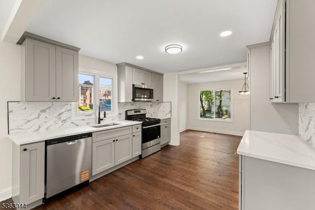 856 Maurice Ave, Rahway City, NJ 07065 - kitchen featuring stainless steel appliances, a sink, decorative backsplash, dark wood-type flooring, and gray cabinetry