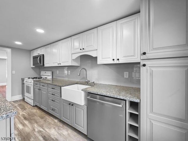 150 Mt Salem Rd, Wantage Twp, NJ 07461 - kitchen with stainless steel appliances, a sink, tasteful backsplash, light wood-style floors, and white cabinetry