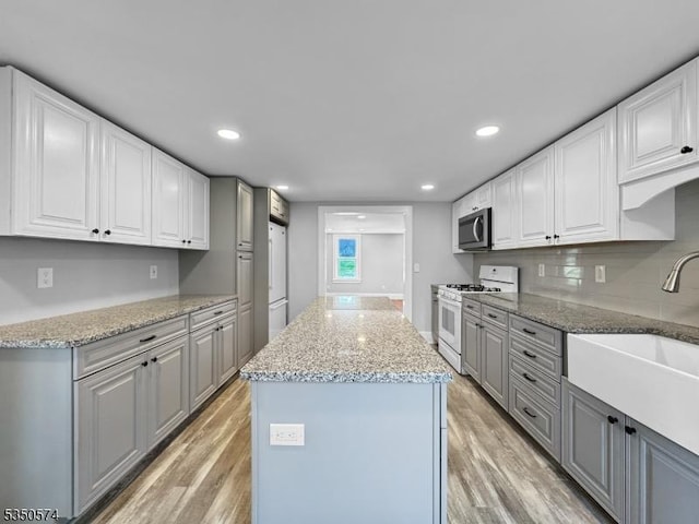 150 Mt Salem Rd, Wantage Twp, NJ 07461 - kitchen with stainless steel microwave, gas range gas stove, a sink, gray cabinets, and a center island