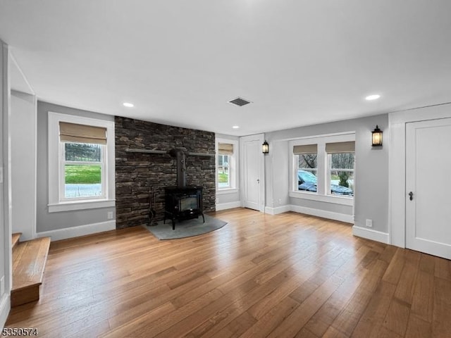 150 Mt Salem Rd, Wantage Twp, NJ 07461 - unfurnished living room featuring a wood stove, wood-type flooring, baseboards, and recessed lighting