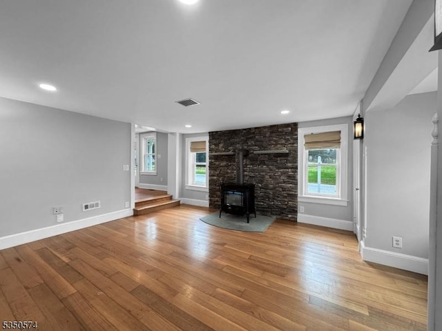 150 Mt Salem Rd, Wantage Twp, NJ 07461 - unfurnished living room with a wood stove, wood finished floors, baseboards, plenty of natural light, and recessed lighting