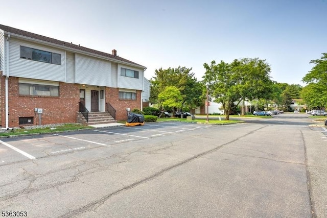 902E Merritt Dr, Hillsborough Twp, NJ 08844 - view of front of property featuring uncovered parking, brick siding, and a chimney