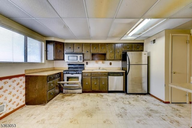 902E Merritt Dr, Hillsborough Twp, NJ 08844 - kitchen with appliances with stainless steel finishes, a sink, light countertops, baseboards, and a drop ceiling