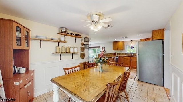 48 Copeley Rd, Hampton Twp, NJ 07860 - dining area featuring a ceiling fan, light tile patterned floors, a wainscoted wall, and a decorative wall