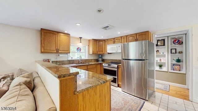 48 Copeley Rd, Hampton Twp, NJ 07860 - kitchen featuring stainless steel appliances, a sink, a peninsula, light tile patterned floors, and stone counters