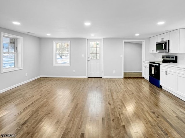 54 Coykendall Rd, Wantage Twp, NJ 07461 - kitchen featuring stainless steel appliances, hardwood / wood-style floors, white cabinetry, recessed lighting, and light countertops