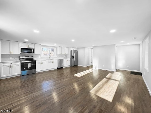 54 Coykendall Rd, Wantage Twp, NJ 07461 - unfurnished living room with dark wood-style flooring, recessed lighting, baseboards, and a sink