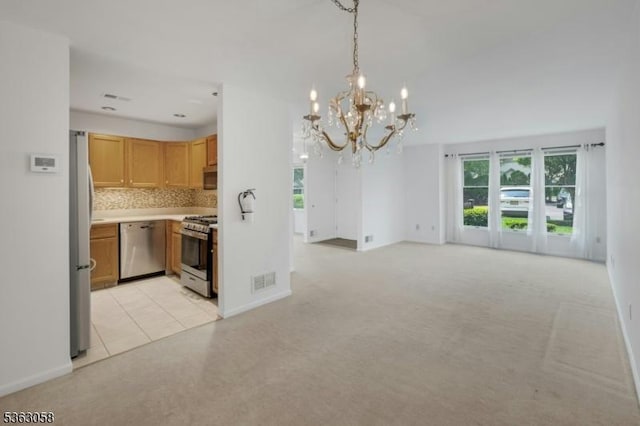 31 Park Edge, Berkeley Heights Twp, NJ 07922 - kitchen featuring stainless steel appliances, a chandelier, open floor plan, decorative backsplash, and light countertops