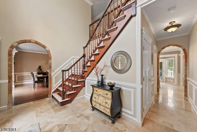 6 Fellen Pl, Hillsborough Twp, NJ 08844 - foyer entrance with arched walkways, a decorative wall, stairway, ornamental molding, and light tile patterned floors