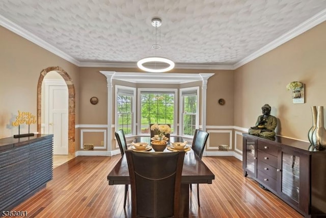 6 Fellen Pl, Hillsborough Twp, NJ 08844 - dining space with a wainscoted wall, hardwood / wood-style floors, arched walkways, a decorative wall, and crown molding