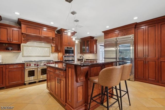 34 Oak Bend Rd, West Orange Twp, NJ 07052 - kitchen with high end appliances, recessed lighting, backsplash, a breakfast bar, and a kitchen island with sink