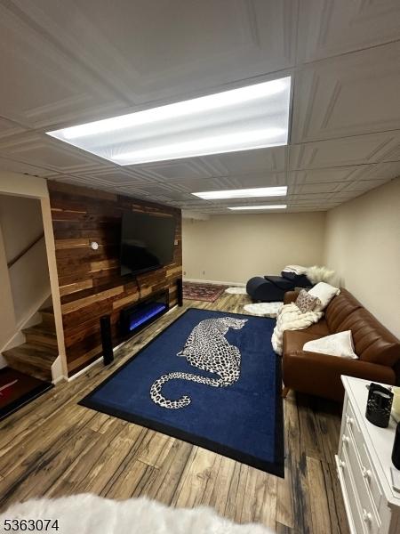 18 Falcon Ln, Washington Twp, NJ 07853 - living area featuring a fireplace, wood finished floors, and stairway