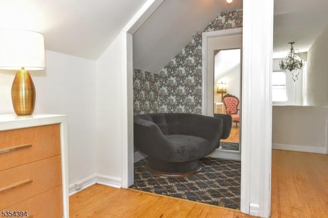 11-06 Marshall Rd, Fair Lawn Boro, NJ 07410 - living area featuring wood finished floors, vaulted ceiling, wallpapered walls, and baseboards