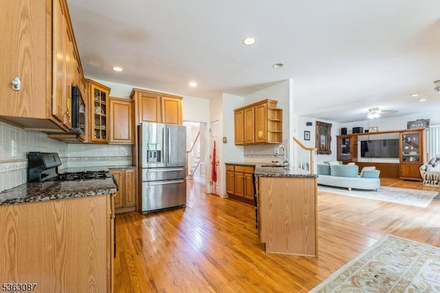42 Stephens Mill Rd, Mount Olive Twp, NJ 07840 - kitchen featuring stainless steel refrigerator with ice dispenser, range, a sink, dark stone countertops, and light wood-style floors