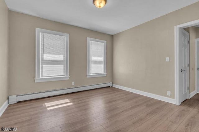 451 Centre St, Nutley Twp, NJ 07110 - spare room with a baseboard heating unit, light wood-style flooring, and baseboards