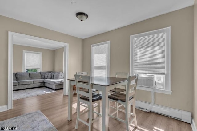 451 Centre St, Nutley Twp, NJ 07110 - dining space with baseboard heating, plenty of natural light, wood finished floors, and cooling unit
