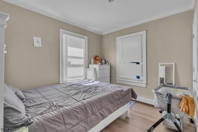 451 Centre St, Nutley Twp, NJ 07110 - bedroom featuring crown molding, wood finished floors, and a baseboard radiator
