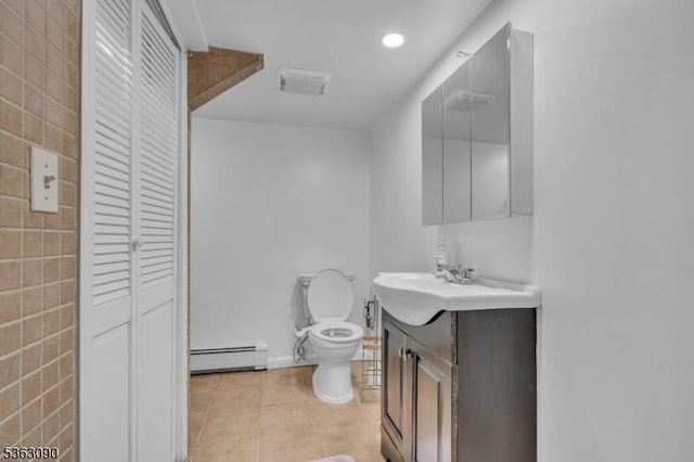 451 Centre St, Nutley Twp, NJ 07110 - bathroom with baseboard heating, vanity, toilet, tile patterned floors, and a closet