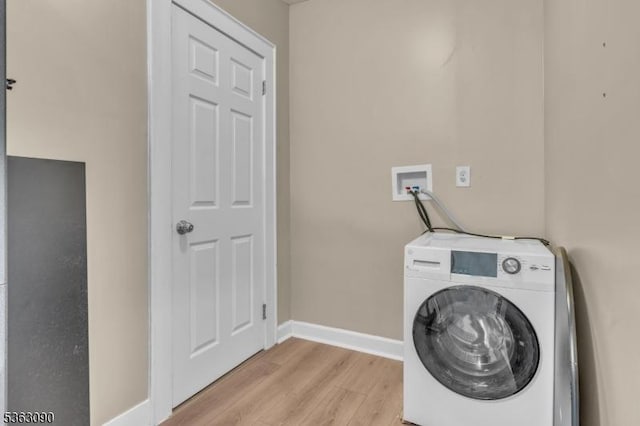 451 Centre St, Nutley Twp, NJ 07110 - laundry area with washer / clothes dryer, light wood finished floors, and baseboards