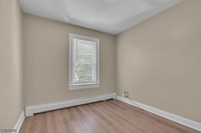451 Centre St, Nutley Twp, NJ 07110 - spare room with a baseboard heating unit, wood finished floors, and baseboards