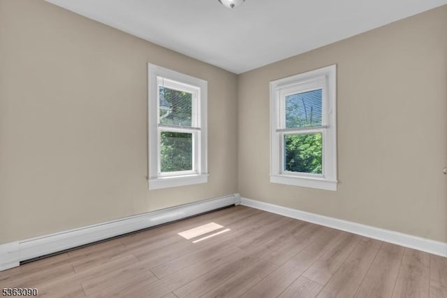 451 Centre St, Nutley Twp, NJ 07110 - empty room featuring baseboard heating, wood finished floors, and baseboards