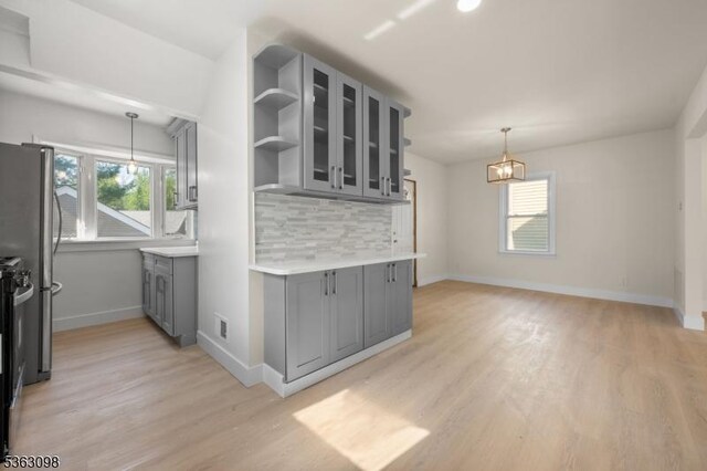 1250 Wildwood Ter, Union Twp, NJ 07083 - kitchen featuring gray cabinets, light wood-type flooring, glass insert cabinets, and tasteful backsplash