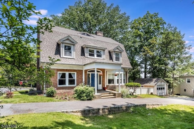 1 Walden Pl, Montclair Twp, NJ 07042 - shingle-style home featuring brick siding, a shingled roof, a chimney, and a front lawn